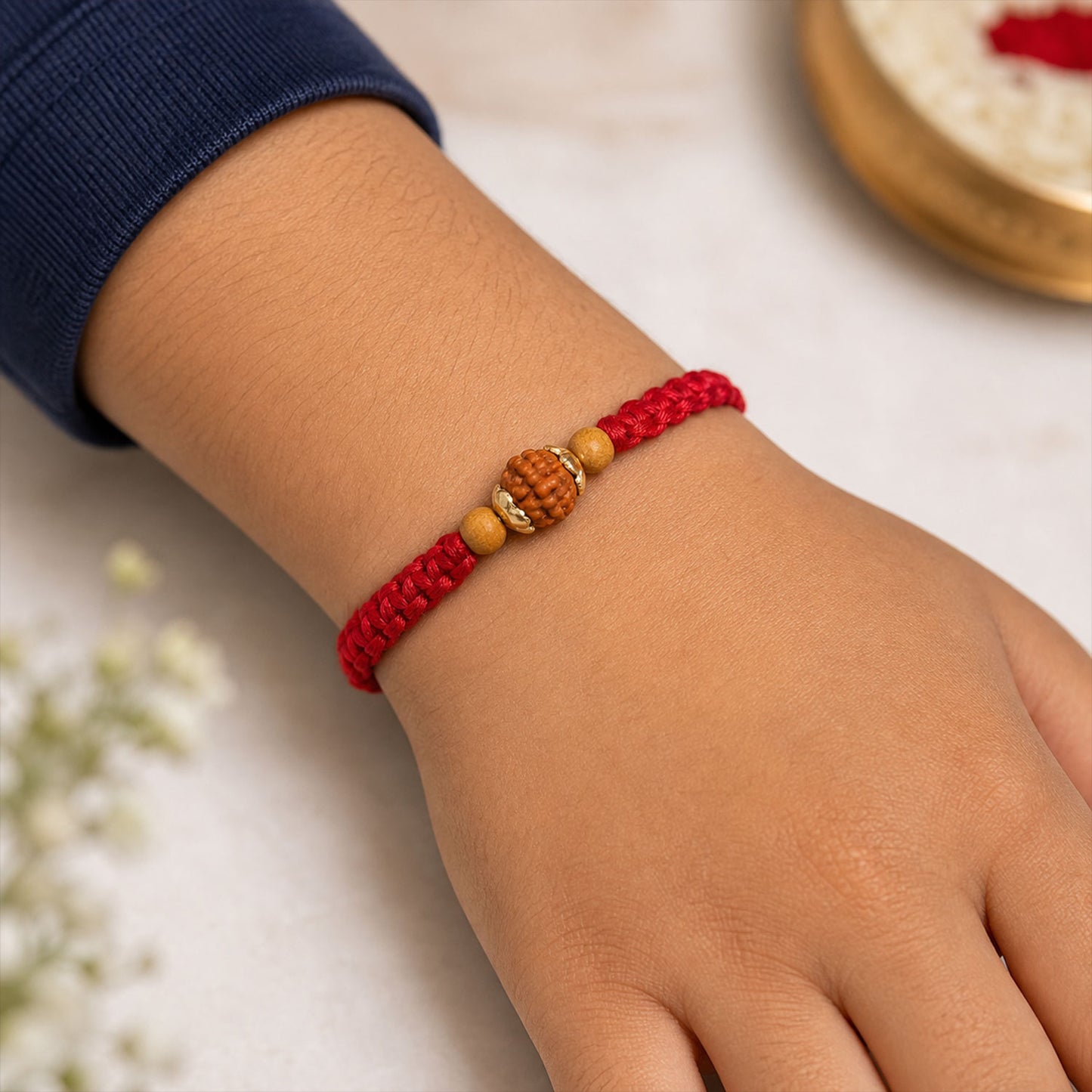 Red Braided Rakhi with a Natural Rudraksha Bead Pendant Accent