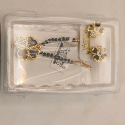 Full set of black clover mangalsutra necklace and matching earrings on display