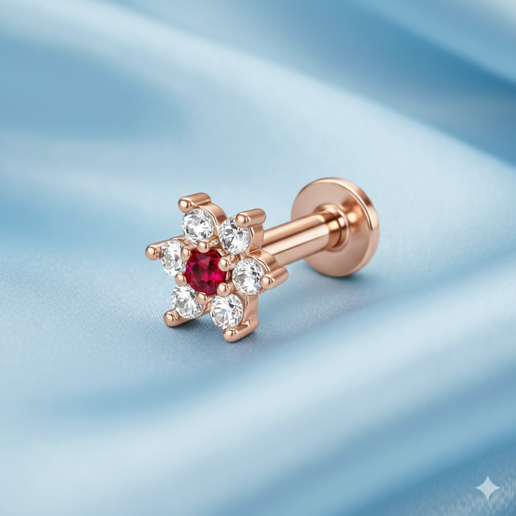 Close-up of ruby-centred rose gold floral labret nosepin stud with cubic zirconia petals