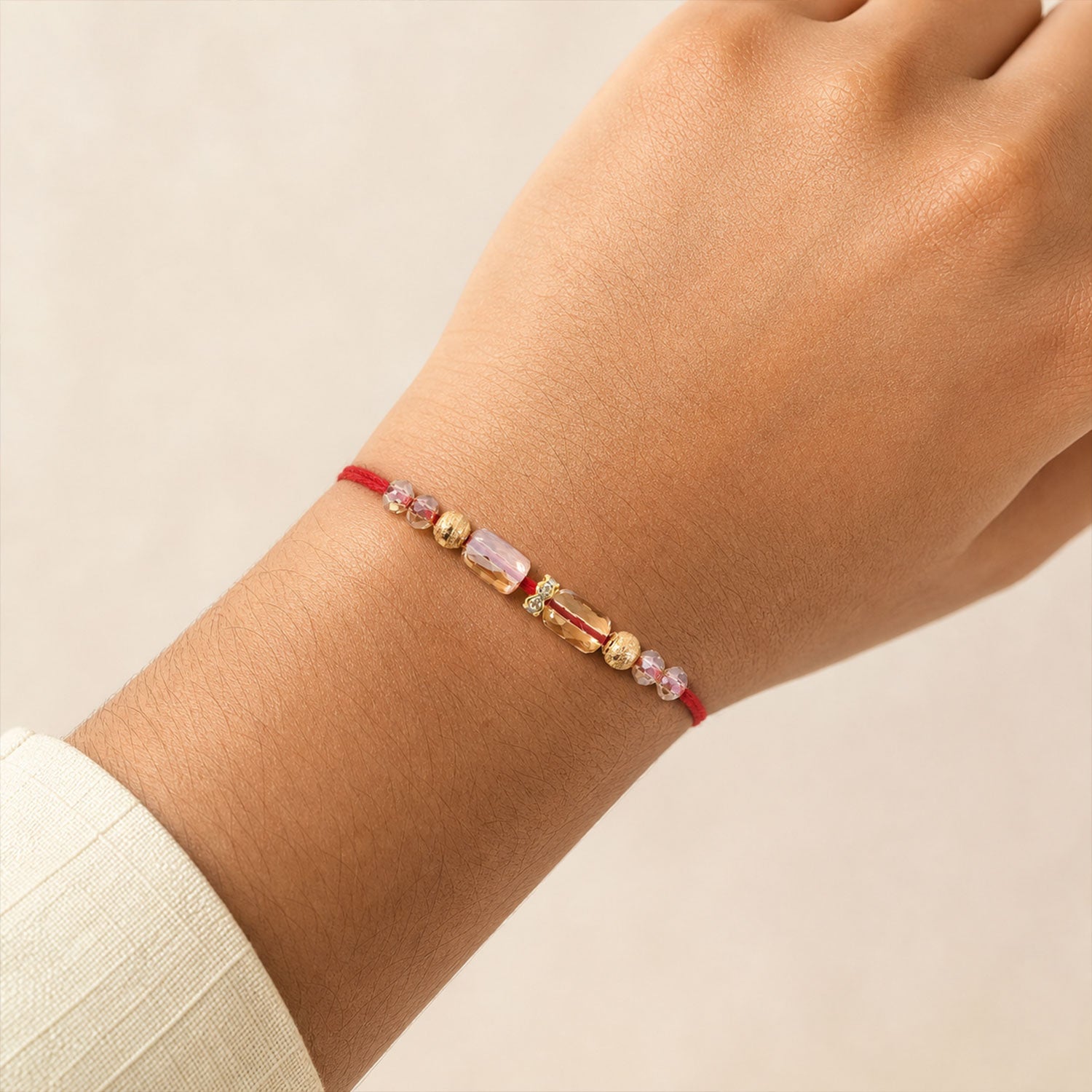 Red Thread Rakhi with Champagne Crystal Beads and Golden Accents