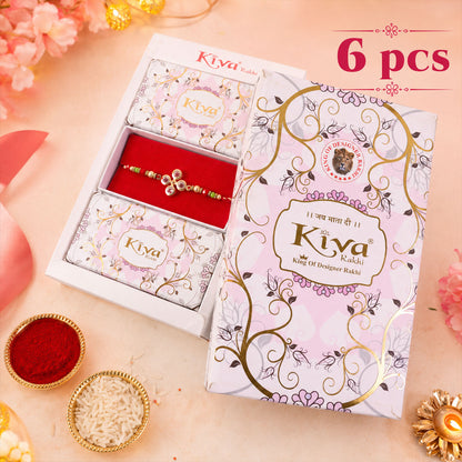 Four Crystal Clover Rakhi with Gold Bezels, Roli Chawal Coin and Floral Gift Packing