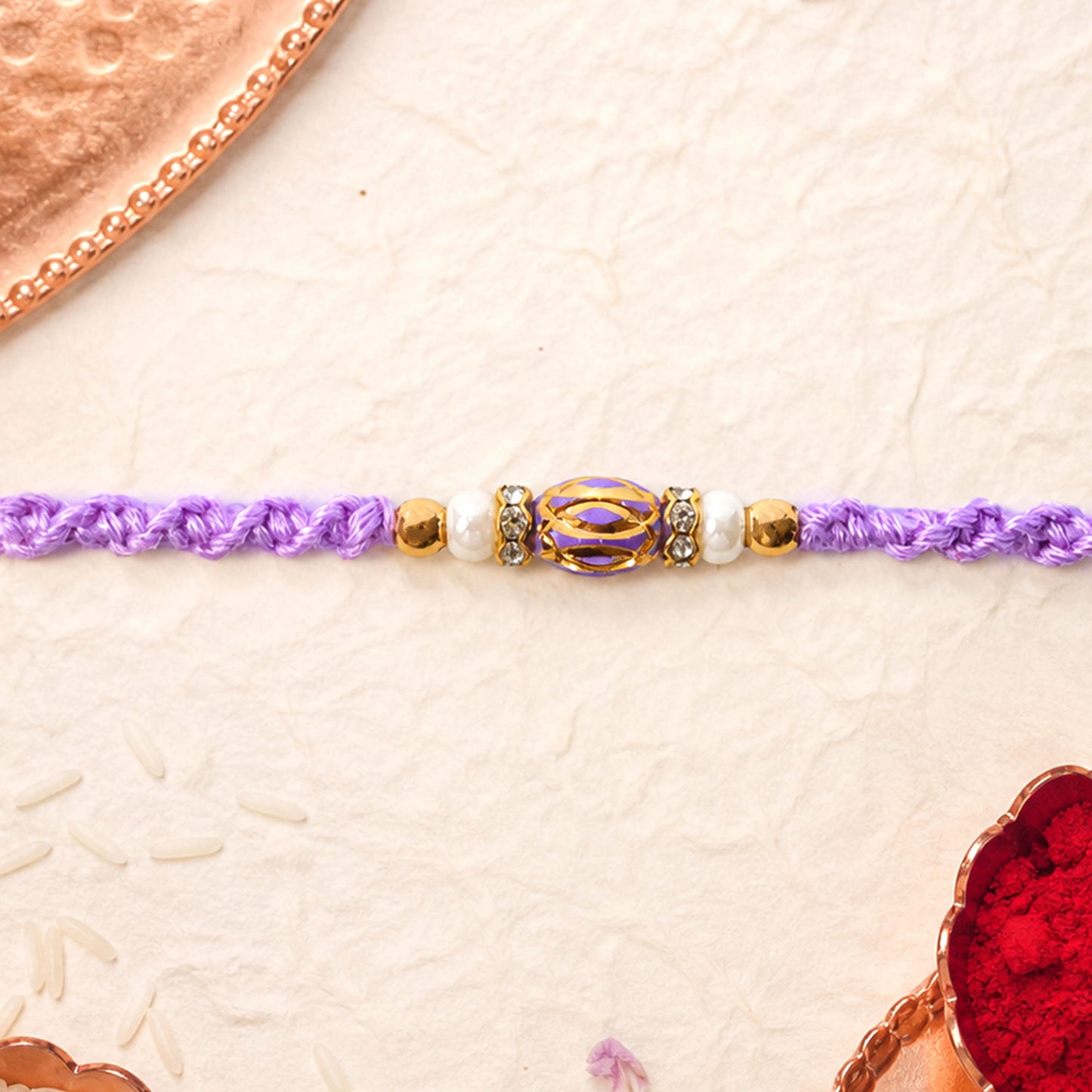 Purple Braided Rakhi with a Sparkling Crystal Oval Pendant Bead