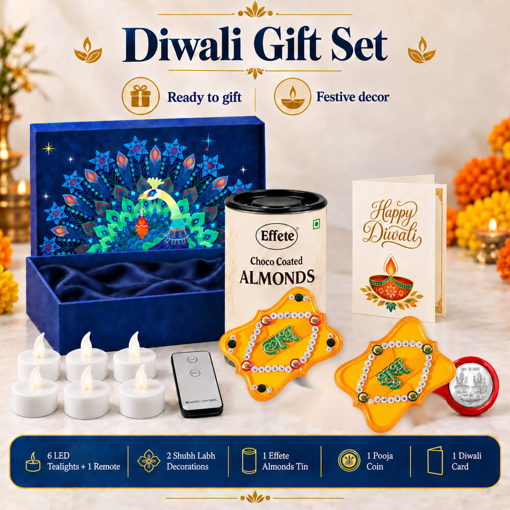 A Diwali gift set with a blue peacock box, choco almonds, LED tealights, remote, Shubh-Labh decor, and a silver coin is