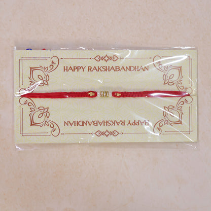Red Braided Rakhi with White Beads and Antique Gold Accent Charms