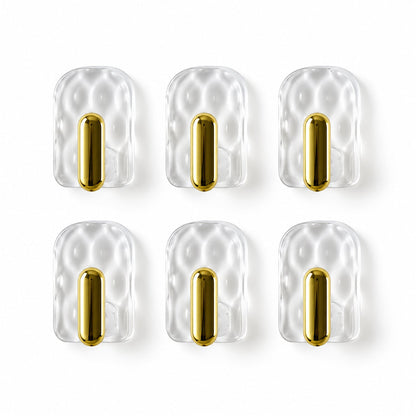 Six individual clear plastic hooks with gold accents arranged in two rows against a plain white background.