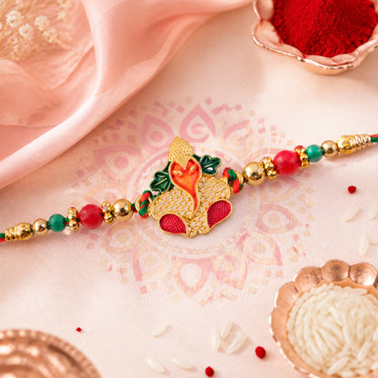 Gold Ganesha Pendant Rakhi with Red and Green Enamel