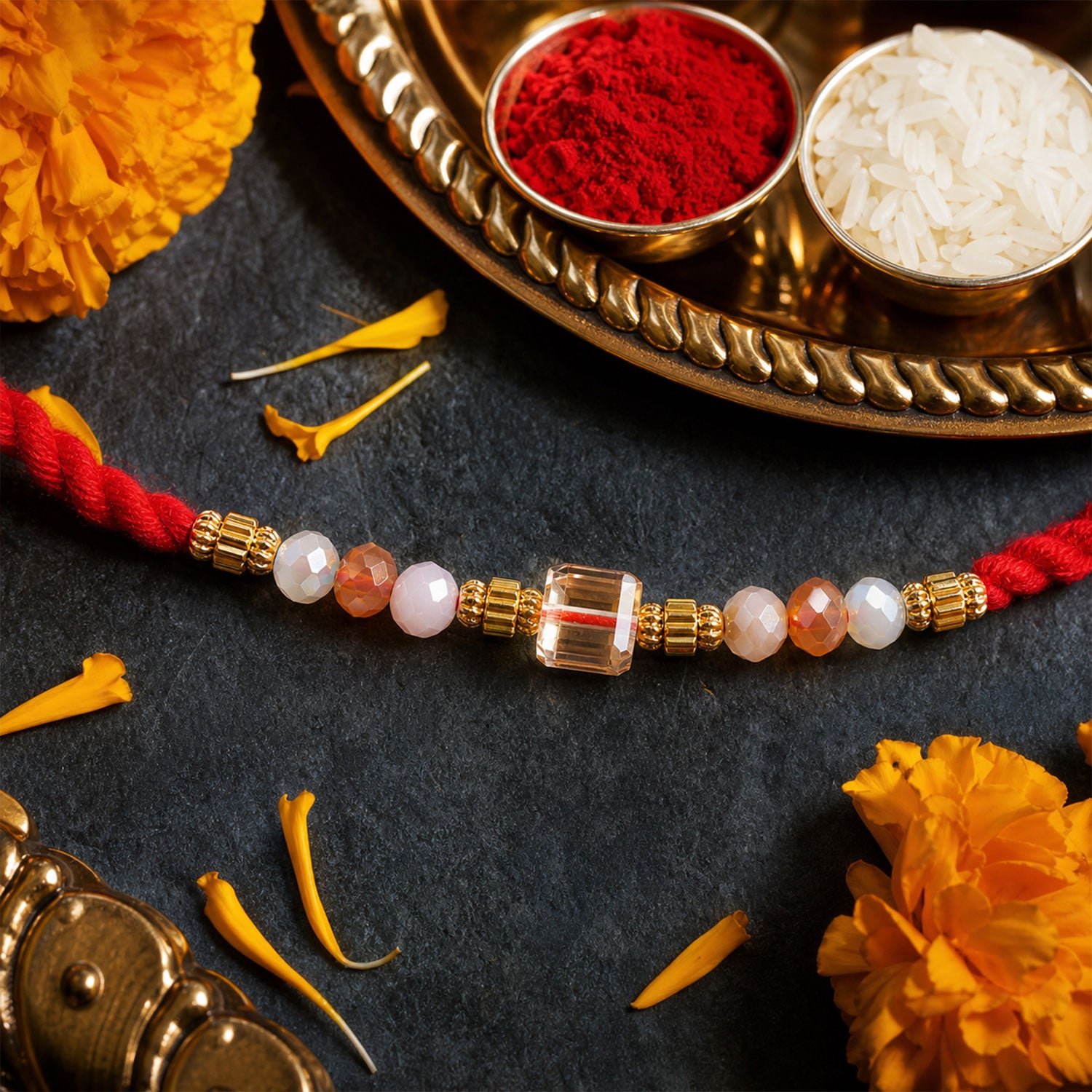 Red Thread Rakhi with Peach and Rose-Toned Crystal Bead Pendant