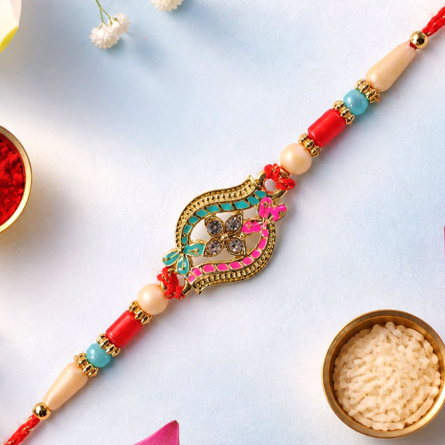 Golden Filigree Oval Floral Centerpiece Rakhi with Pink & Turquoise Enamel Detail