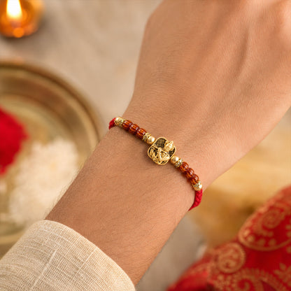Red Beaded Rakhi with Antique Gold Krishna Charm and Wooden Beads