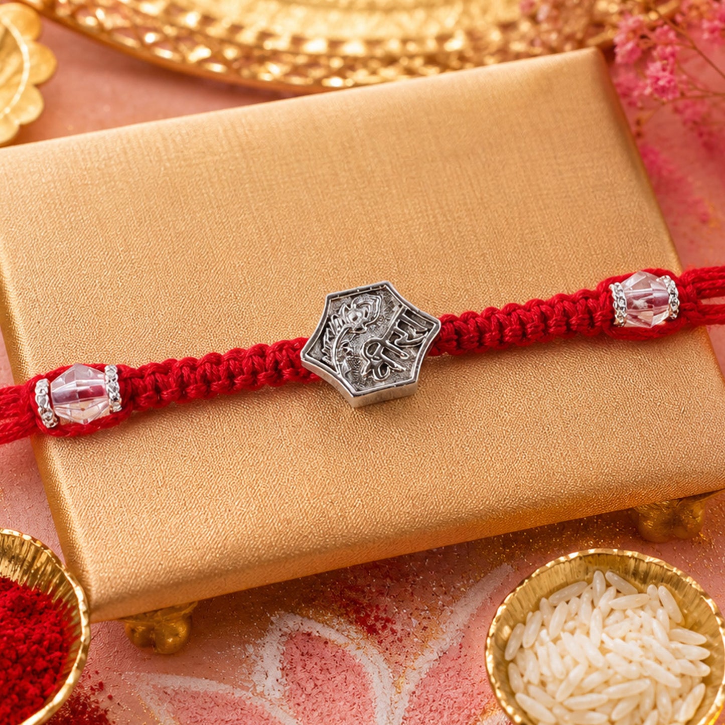 Red Thread Rakhi with Engraved Silver Shield-Shaped Charm Pendant