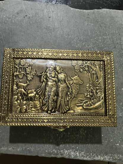 Open handcrafted Radha Krishna golden jewelry box showing interior