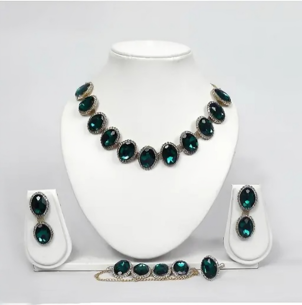 Emerald green crystal jewelry set in silver-tone with necklace, earrings, bracelet, and ring