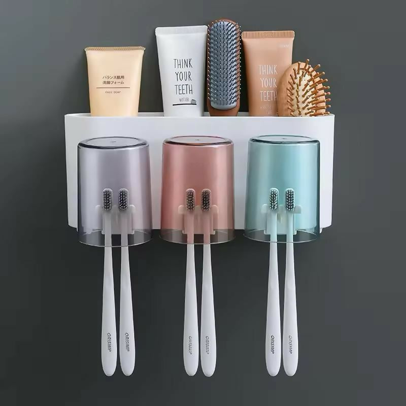 Self adhesive 3-cup toothbrush holder mounted on bathroom wall