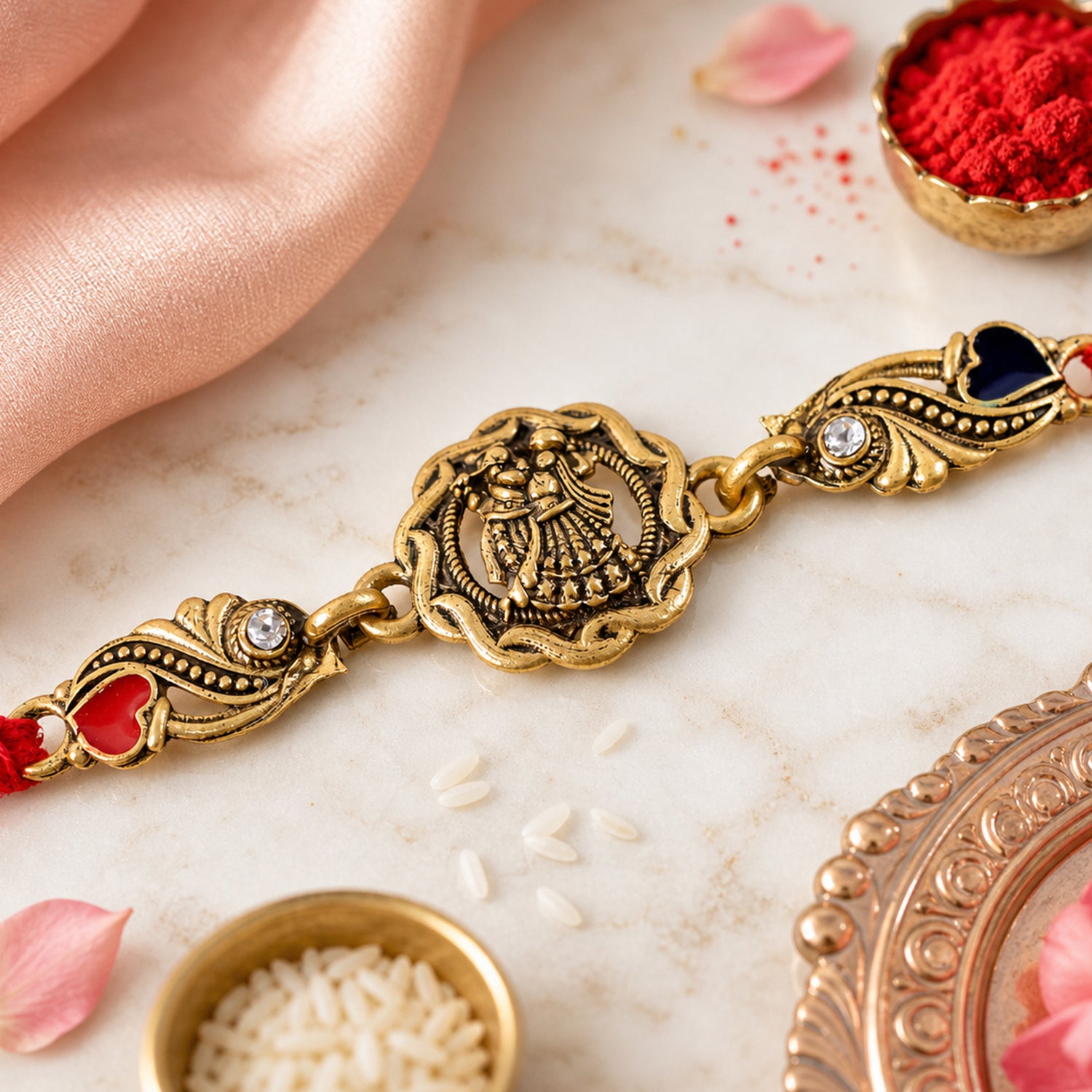 Antique Gold-Toned Radha Krishna Rakhi with Crystal Accents, Enamel Hearts & Red Thread