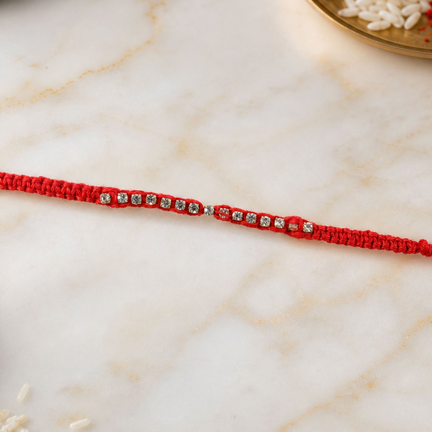 Red Thread Rakhi with a Row of Sparkling Crystal Rhinestone Beads