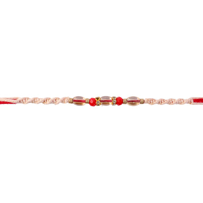 Peach Twisted Cord Rakhi with Red and Sparkling Crystal Bead Accents