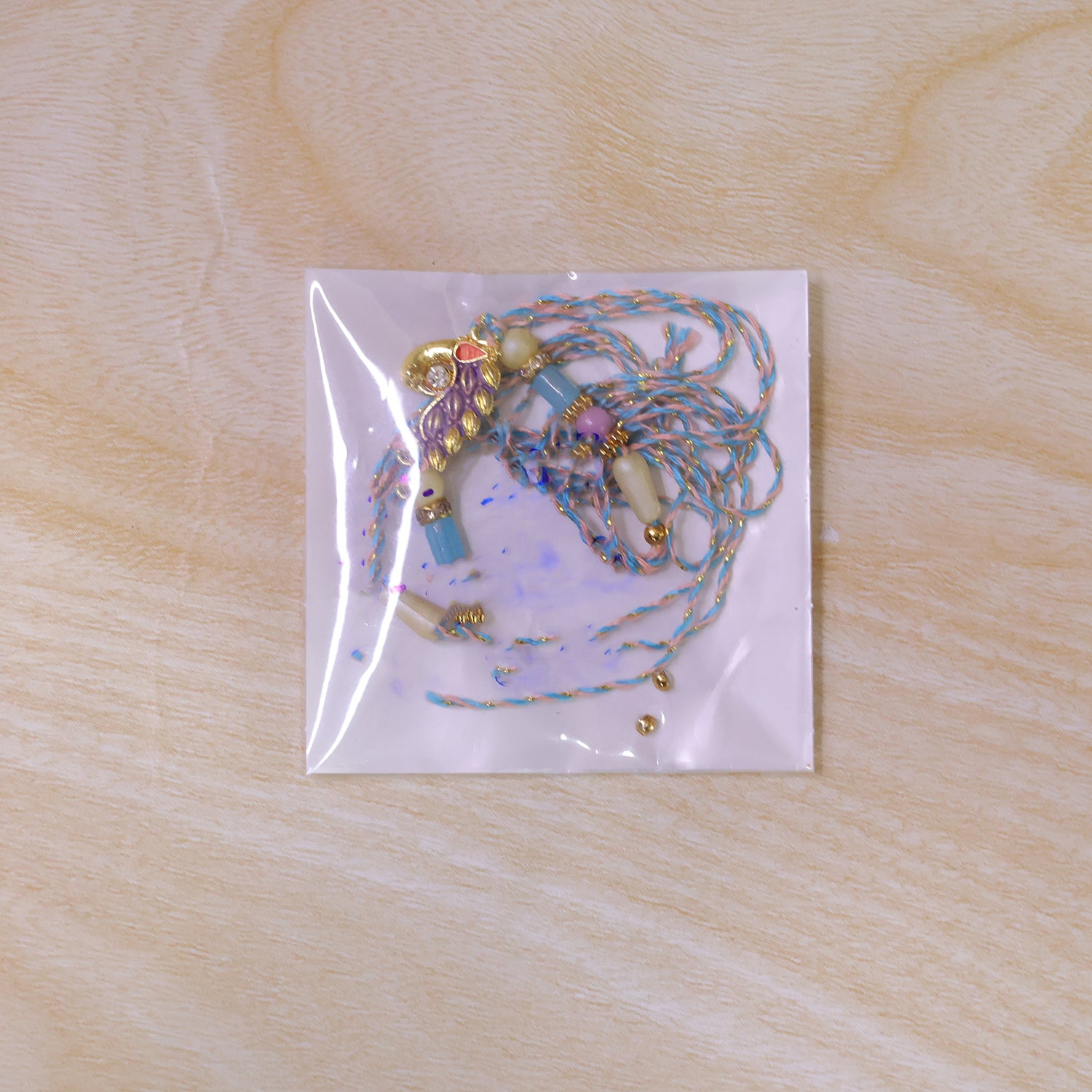 Blue Enamel Peacock Pendant Rakhi with Pastel Beads