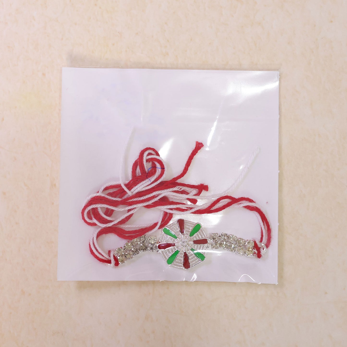 Elegant Rakhi showcasing Chakra Wheel Charm, crystal accents and wrist style for Gift
