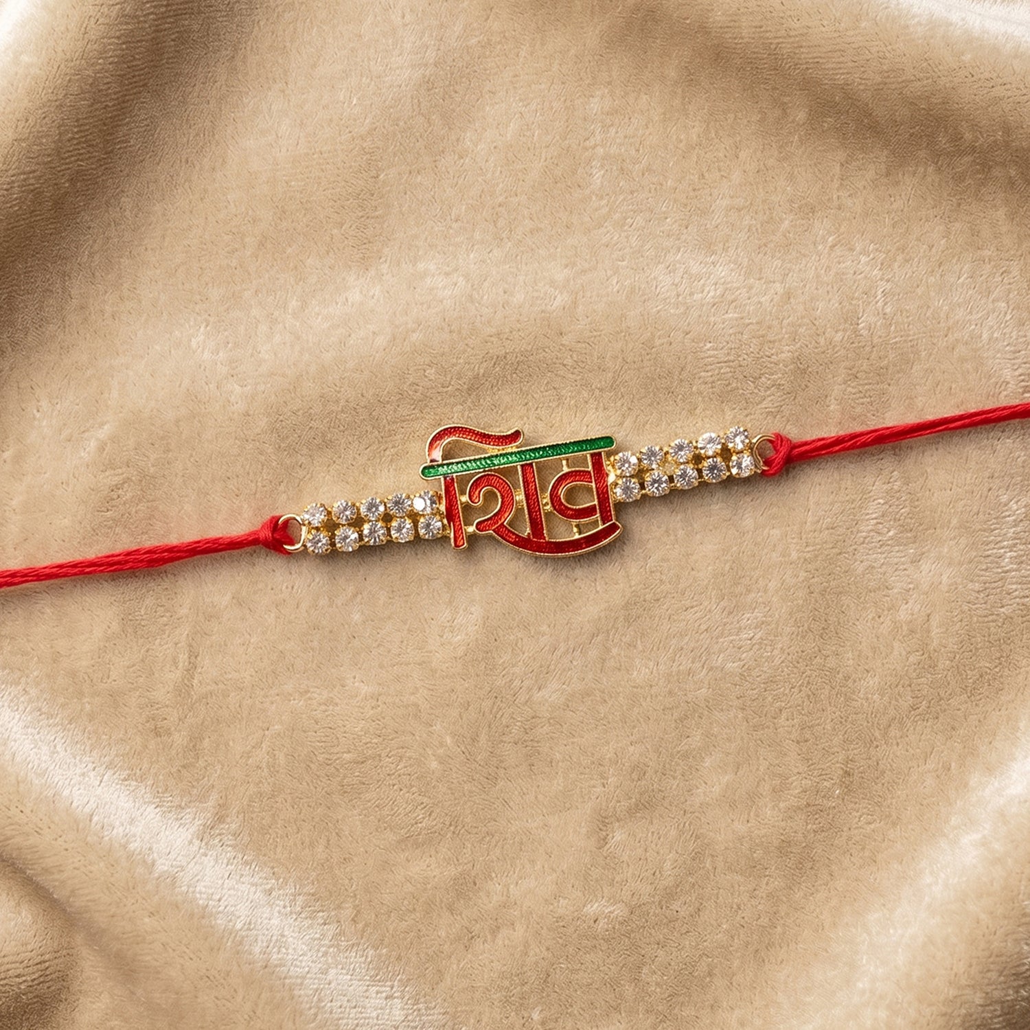 Shiv Letter Rakhi with Crystal Row and Red Mauli Thread