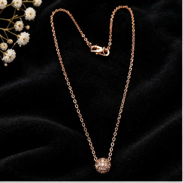 Model wearing gold-tone floral cluster pendant necklace with a black outfit