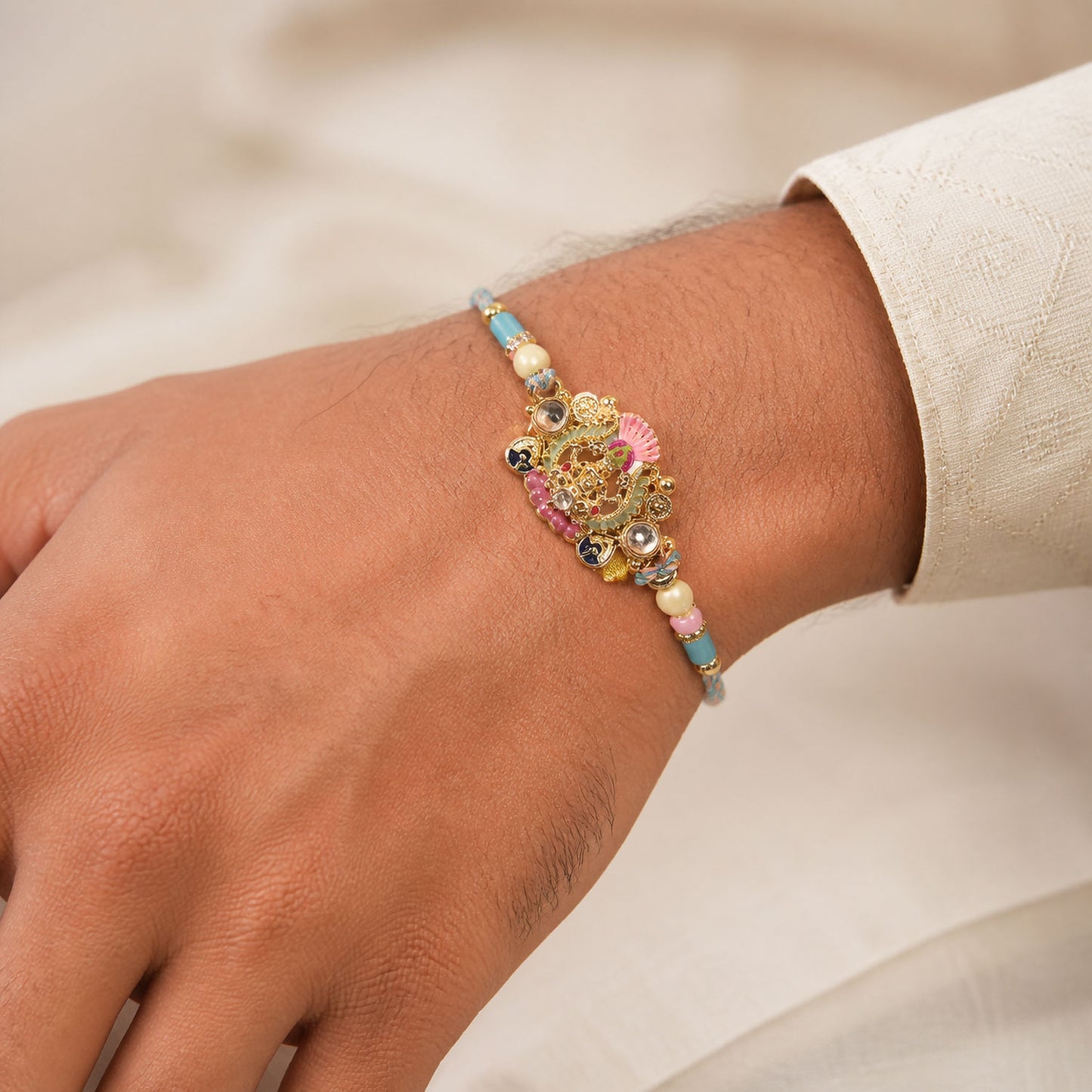 Gold Peacock Kundan Pendant Rakhi with Pastel Beads