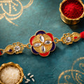 Ornate Rakhi with Floral Medallion, multicolor stones and display look for Gift Use
