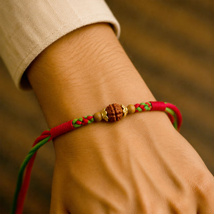Green Red Designer Rakhi with Golden Bead Accents and Traditional Festive Beauty