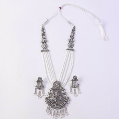 Silver necklace set displayed on ethnic dress