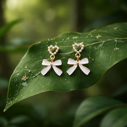 Vintage style pearl and gold earrings angled on white surface