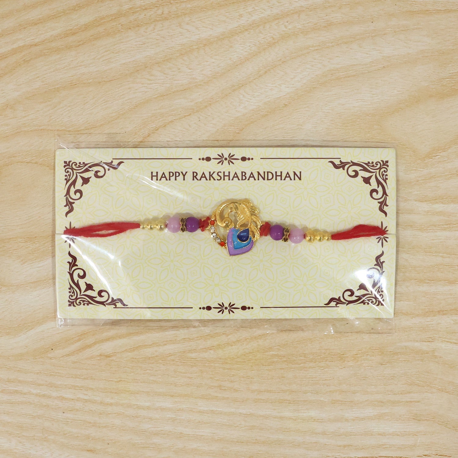 Purple blue peacock designer Rakhi with traditional styling and soft thread