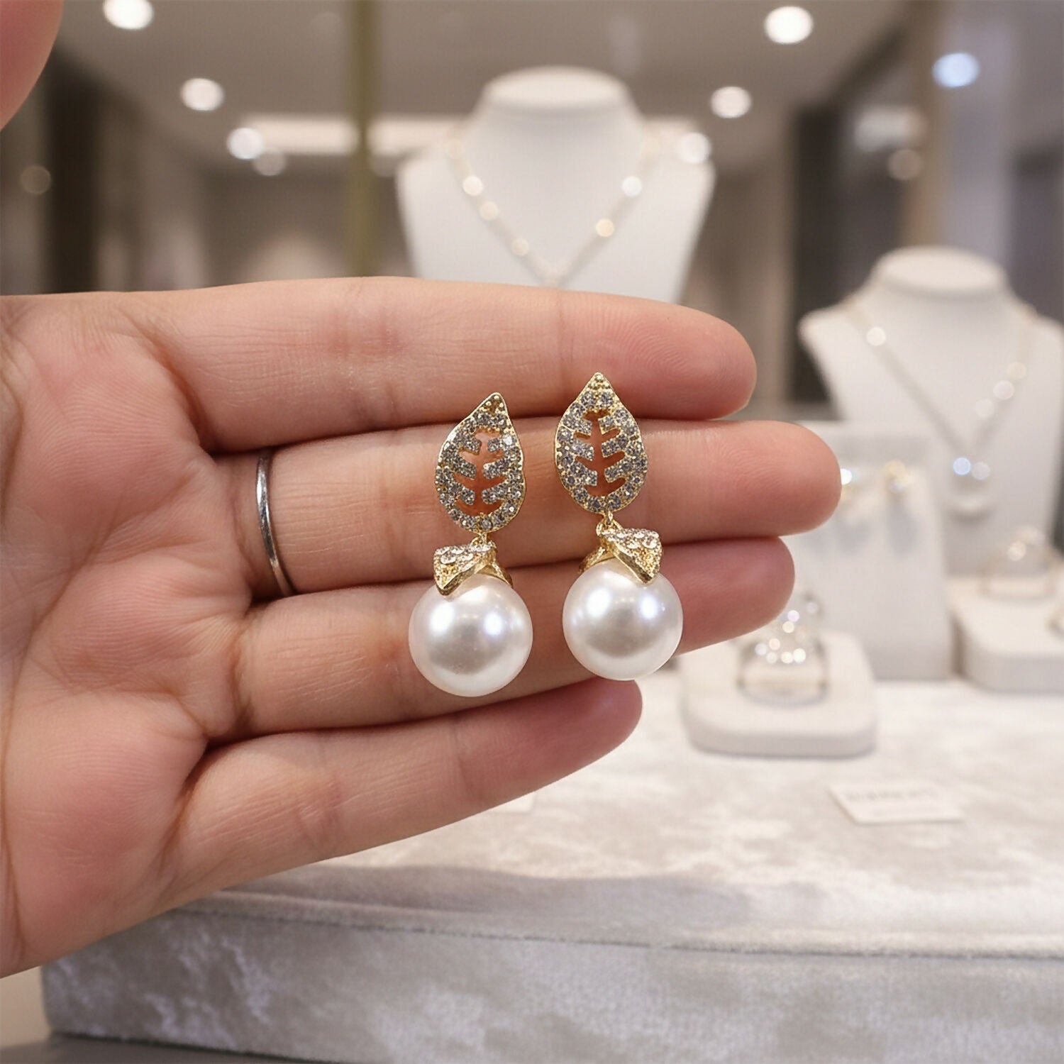 Pearl drop detail of earrings