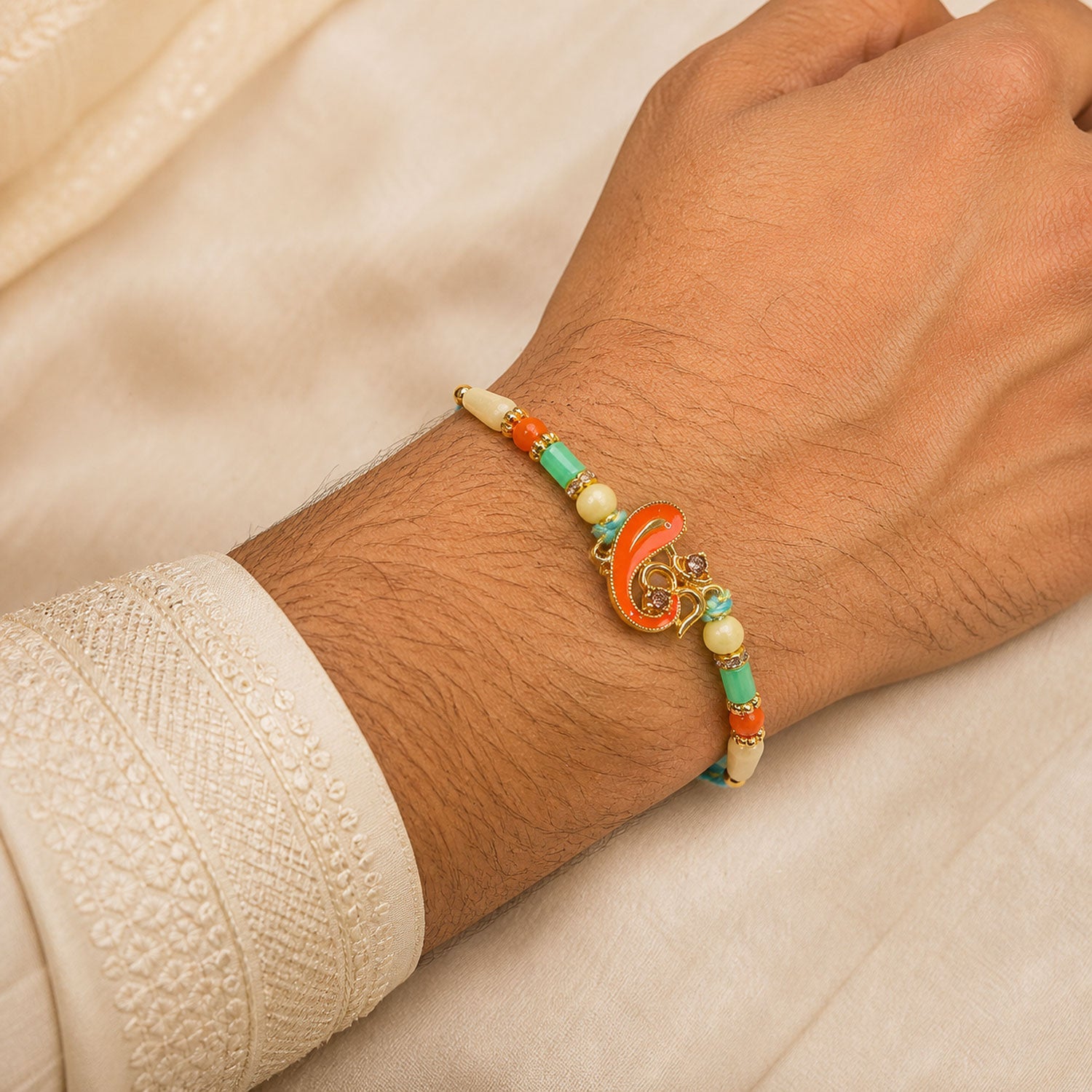 Traditional Rakhi with Om Symbol Charm and leaf detail in thread style for Gift Use