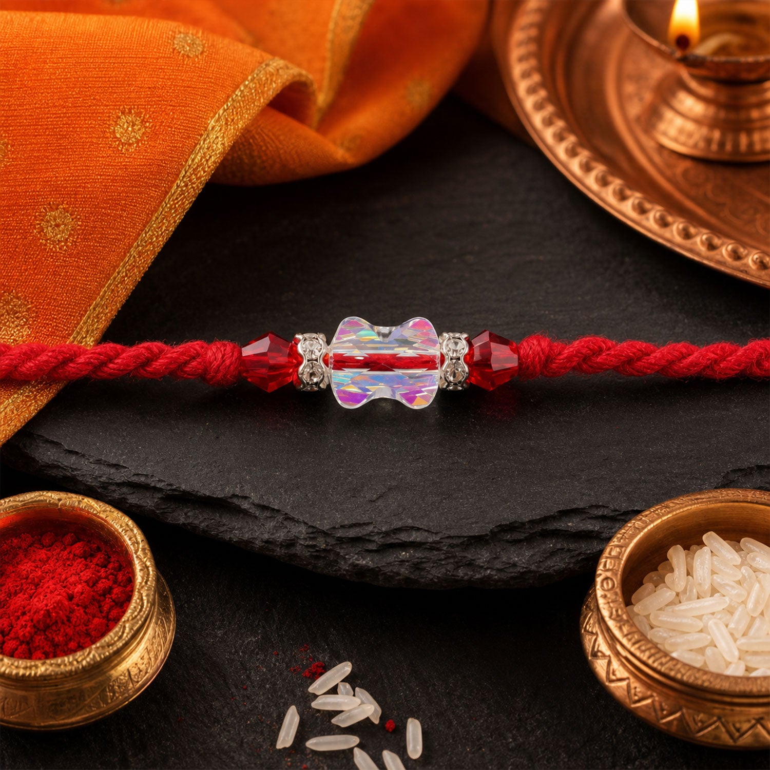 Red Thread Rakhi with an Iridescent Bow-Tie Shaped Crystal Bead