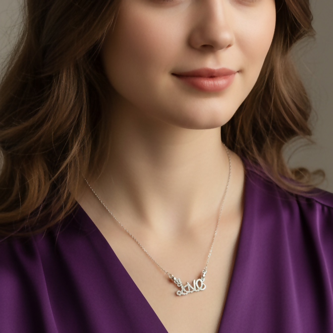Close-up of silver plated Love Script pendant on delicate cable chain