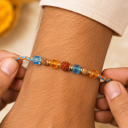 Blue Beaded Bracelet Rakhi with Golden Spacers and Colorful Festive Charm