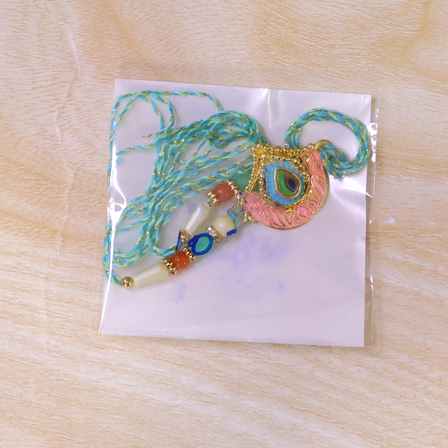 Peacock Feather Crown Pendant Rakhi with Pink Enamel