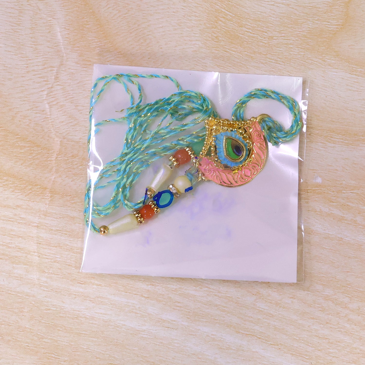 Peacock Feather Crown Pendant Rakhi with Pink Enamel