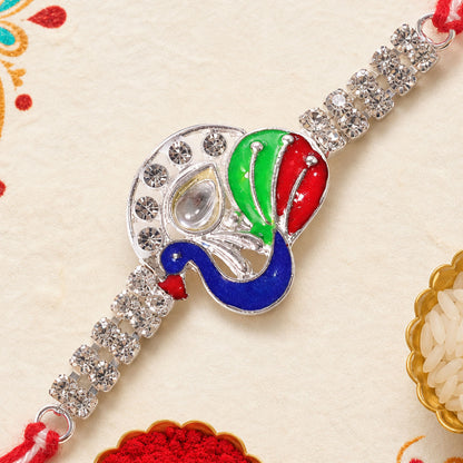 Silver-Toned Peacock Rakhi with Multicolor Enamel, Kundan-Style Stone & Double Crystal Chain