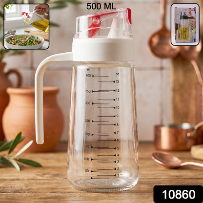 500ml Glass Oil Dispenser Bottle with Auto-Flip Cap and Measurement Markings Pouring Oil on Salad