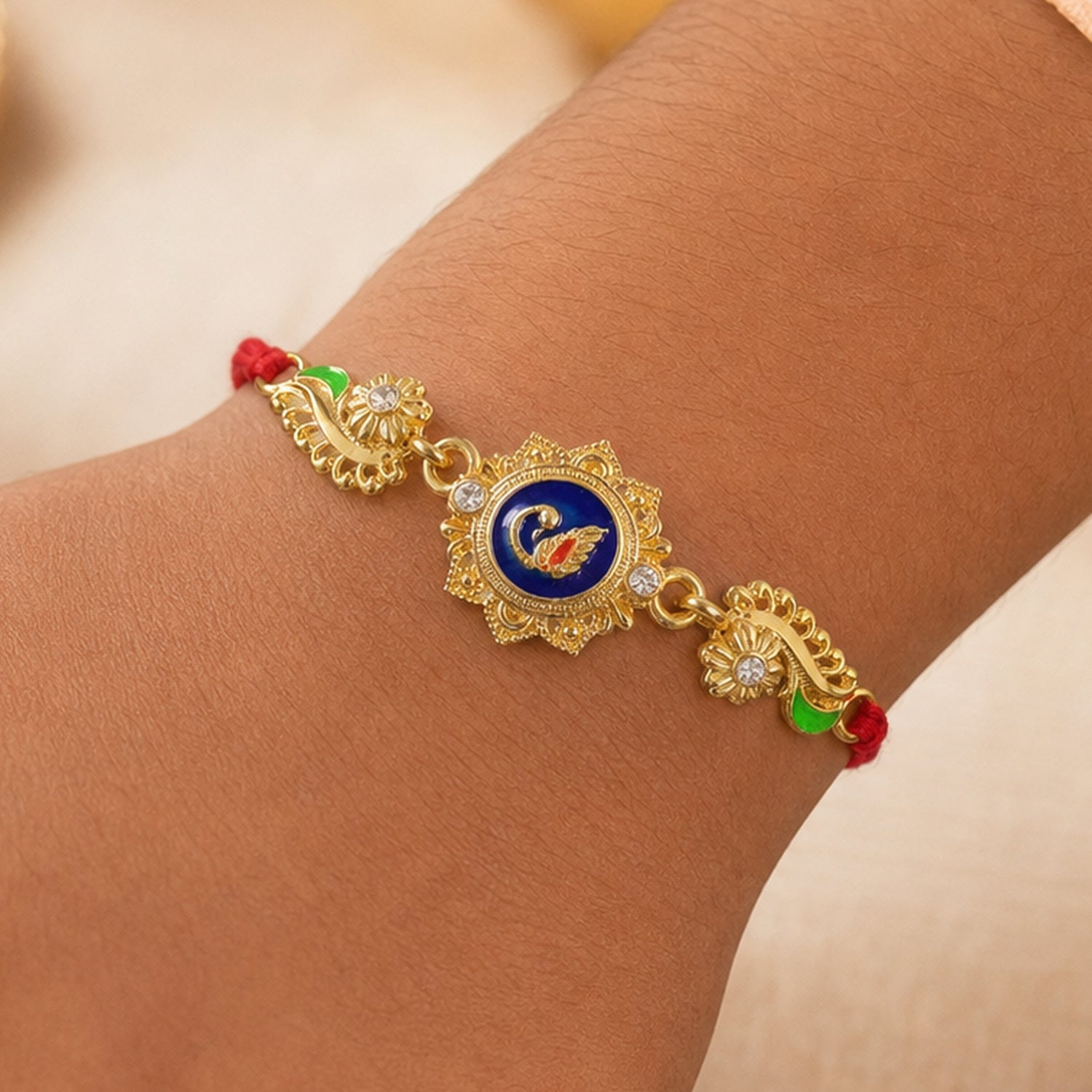 Ornate Rakhi showcasing Blue Oval Medallion, metal trims and chain look for Gift Use