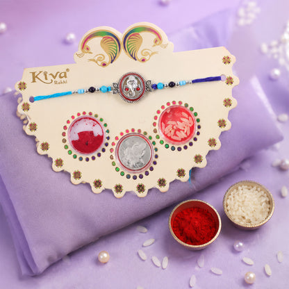 Round Ganesha Medallion Rakhi with Blue Thread, Roli Chawal Coin and Peacock Card Packing