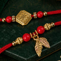 Red Bead Floral Rakhi Pair with Leaf Charms for Bhaiya Bhabhi Couple Celebration