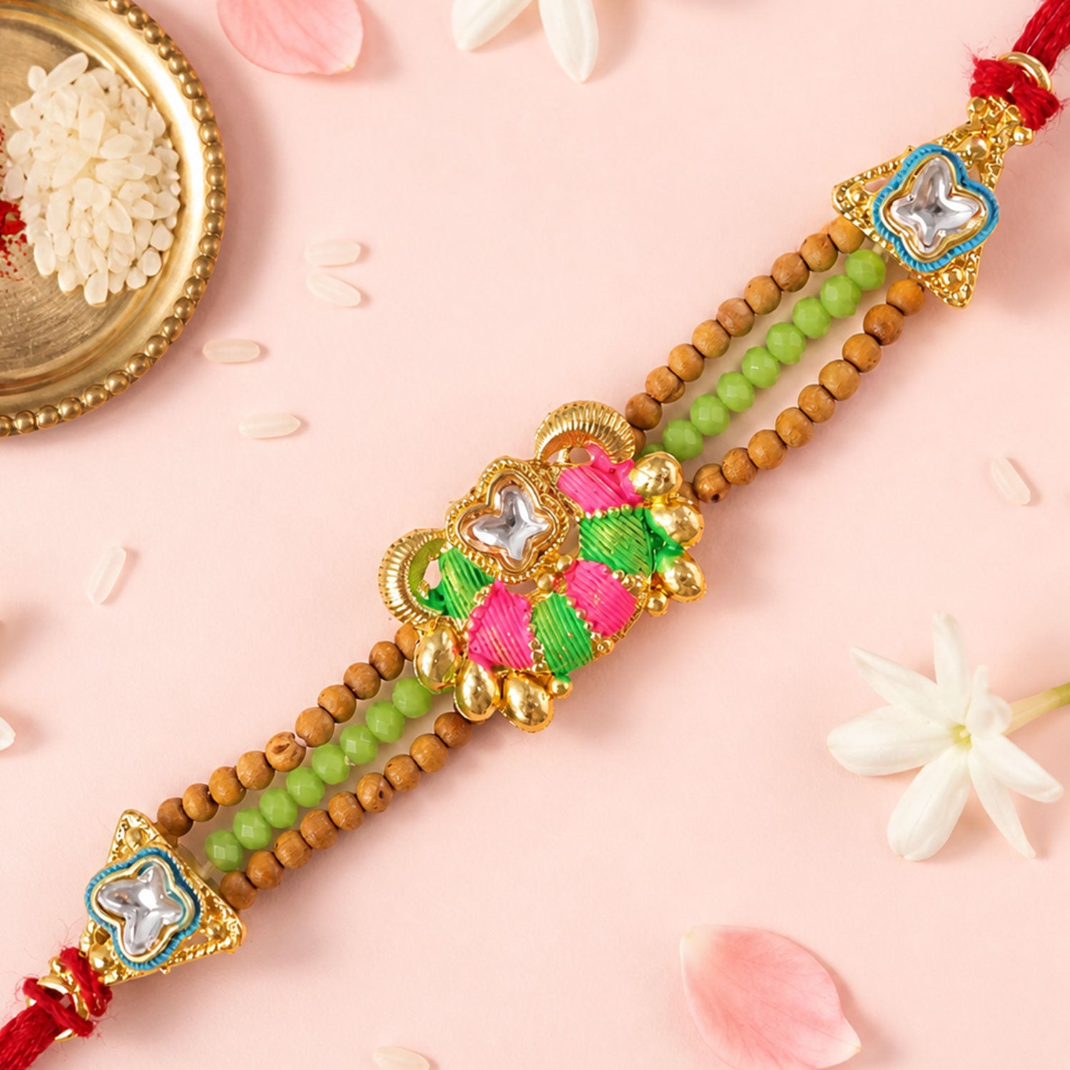 Green Beaded Floral Rakhi with Pink Center and Colorful Festive Gifting Elegance