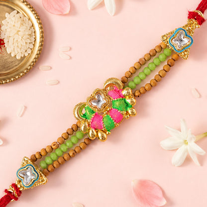 Green Beaded Floral Rakhi with Pink Center and Colorful Festive Gifting Elegance