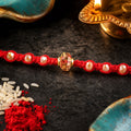 Red Beaded Rakhi with Champagne Crystal Bead and Red Bead Accents