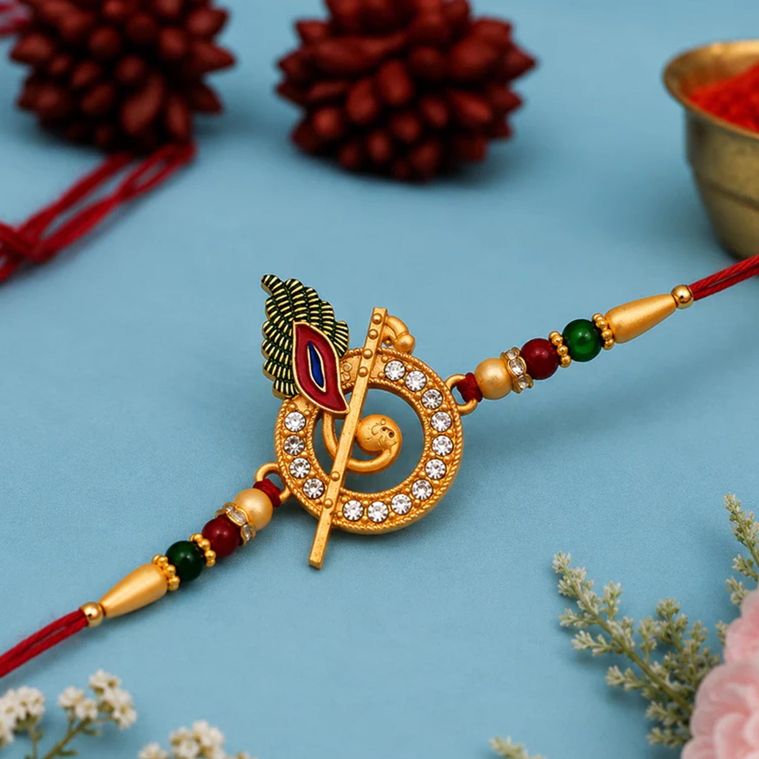 Krishna Bansuri Studded Crystal Rakhi with Cute Doll Keychain Combo (2 Pc)