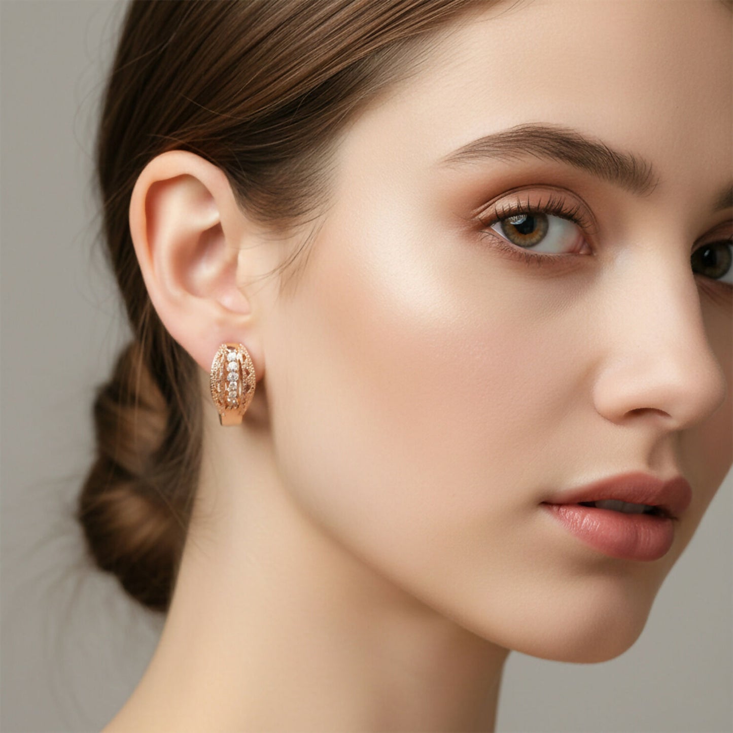 Woman wearing gold finish CZ studded hoop earrings, lightweight and stylish