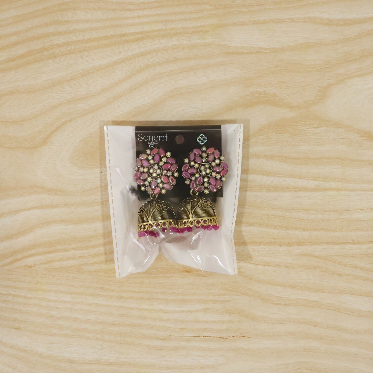Pair of antique golden jhumka earrings with pink stone floral tops