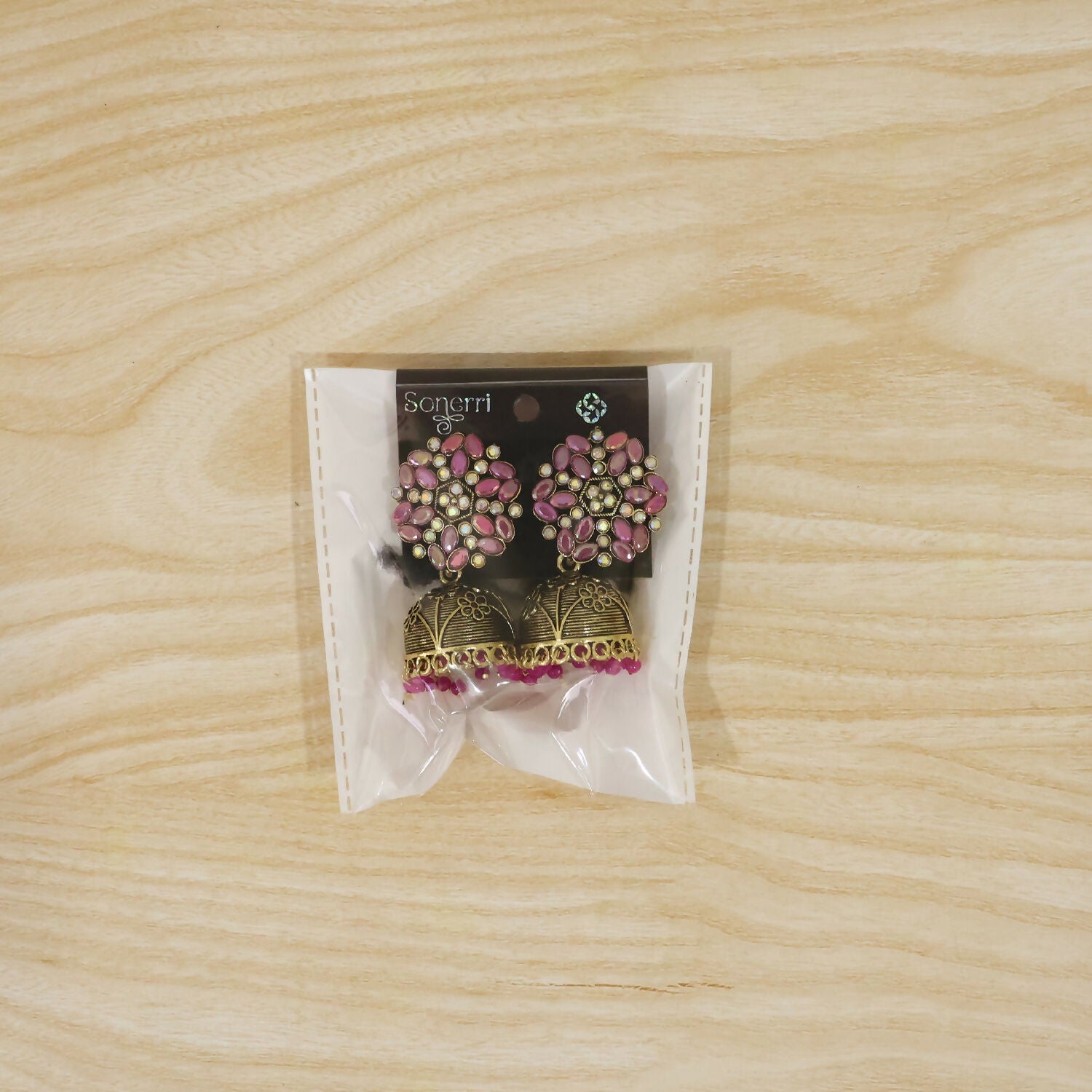 Pair of antique golden jhumka earrings with pink stone floral tops