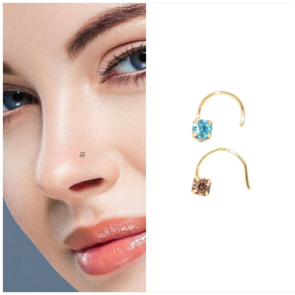 Close-up of gold plated clear crystal nose pin with secure curved hook